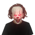 Creepy Smiling Demon Mask with glowing red eyes and messy hair, perfect for Halloween or costume parties.